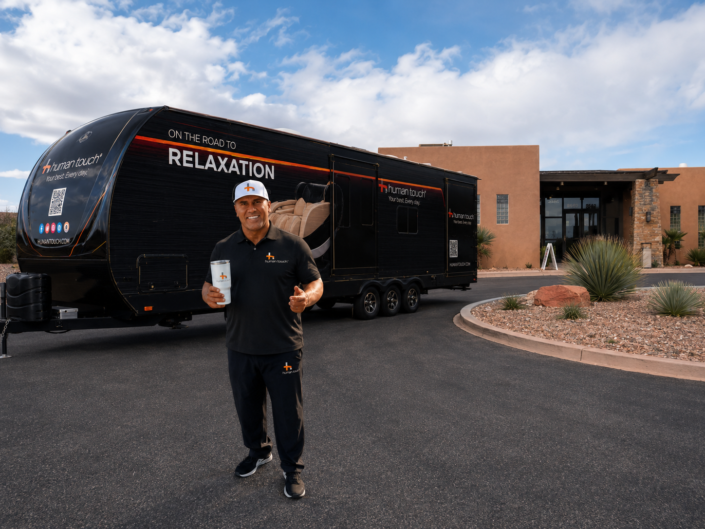 Human Touch team member standing in front of the branded black Recovery Lounge trailer